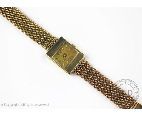 A Gentlemans Universal Geneve gold wristwatch, the rectangular case enclosing further rectangular face and gilt dial with bat