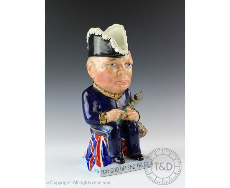 A Clarice Cliff for Wilkinson Ltd Winston Churchill toby jug, c1940, designed by Sir F Curruthers Gould, modelled seated on a