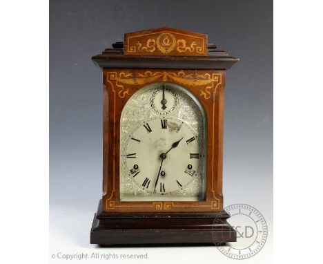 A late Victorian inlaid mahogany eight day mantel clock, with silvered Roman numeral dial, and Kienzle movement striking on f