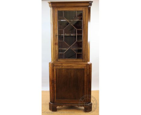 A George III mahogany corner cabinet, with astragal glazed door above a cupboard door, on bracket feet, 195cm H x 78cm W