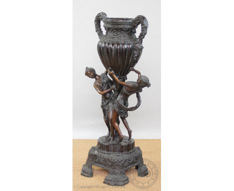 A modern bronze figural conservatory jardiniere, modelled as two female figures supporting a two handled urn, 106cm H