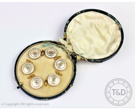 A cased set of six mother of pearl, white enamelled and yellow metal buttons, each designed as a central circular mother of p