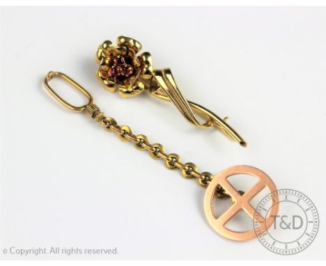 A ruby set floral spray brooch, designed as a single rose set with three central untested rubies, stamped '18ct', weight 7gms