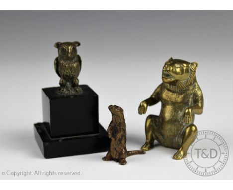A small cast bronze otter, modelled standing upon hind legs, marked to underside, 4cm high, a brass owl mounted on black marb