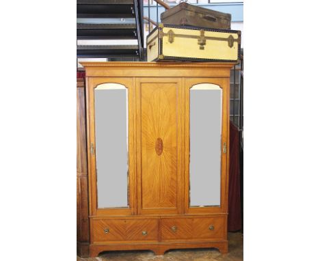 An Edwardian inlaid satinwood wardrobe, with a panelled and a mirrored door, above two drawers, on bracket feet, 212cm H x 16