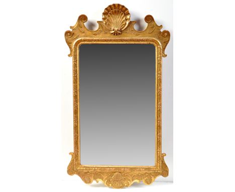 A mid 18th Century style giltwood and gesso wall mirror, surmounted by a shell motif flanked by scrolls, similar decoration t