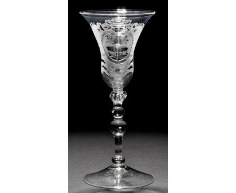 A light baluster goblet of the 'Friendship' type, the bell bowl engraved with clasped hands within an elaborate crowned carto