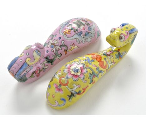 Two Chinese Famille Rose belt hooks, enamel painted with fruit and foliate scrolls on rose pink and lemon yellow grounds, myt