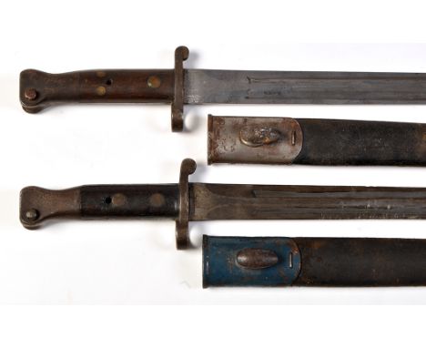 Two 19th Century British Lee Metford Mk I bayonets, each with double edged blades and oak mounted grips, metal and leather sc