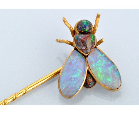 An opal and yellow metal fly pattern tie pin, set with bolder opal body and opal wings (some damage to legs), on a yellow met