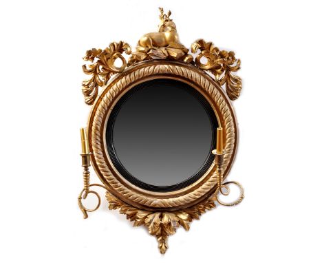 *A Regency giltwood girandole wall mirror, the circular convex plate within reeded ebonised slip, the spiral twist frame with