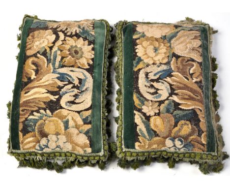 A pair of 17th/18th Century Flemish tapestry fragment cushions, with green velvet backing and tassel edges, 16 x 10in. (41 x 