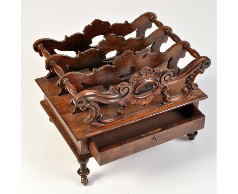 A Regency rosewood canterbury, the three sections decorated with scrolling pierced slats joined by turned supports, fitted a 