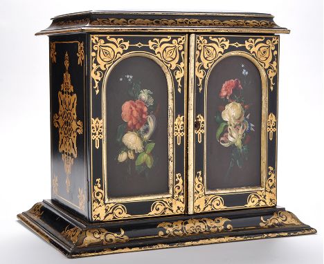 A 19th Century black lacquer cabinet, decorated throughout with gilt leaf scrolls, the caddy top above a pair of arch panel d