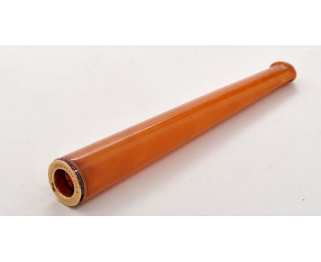 An amber, gold and ruby mounted cheroot holder, by Lacloche Freres, Paris, 9.5cms (3 3/4in.).