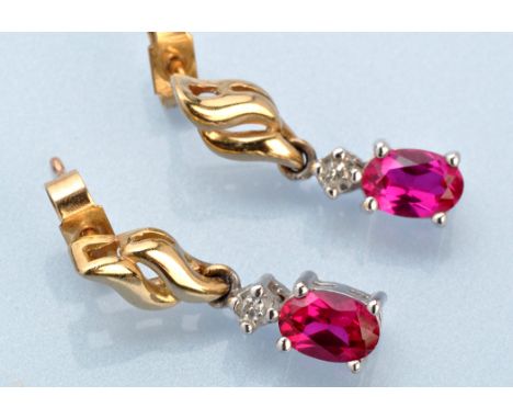 A pair of ruby and diamond drop earrings, the oval facet cut rubies four claw set below illusion mounted eight-cut diamonds, 