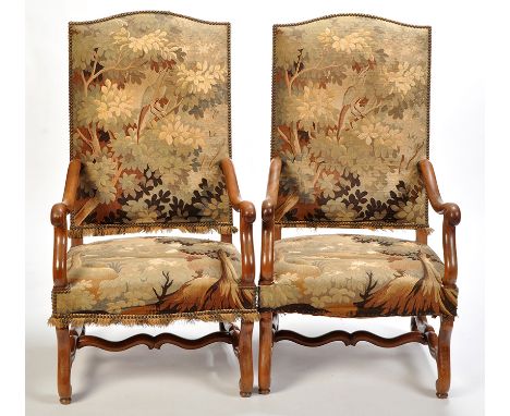 A pair of 19th Century mahogany hall chairs, the high backs and seats upholstered in needlework tapestry depicting a country 