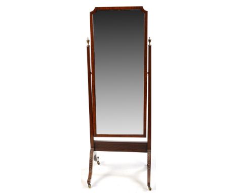 An early 20th Century mahogany cheval mirror, the rectangular bevelled plate with canted top corners, flanked by square taper