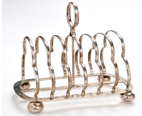 An Edwardian seven bar toast rack, by Walker & Hall, Sheffield 1908, with ring handle and bun feet, 7cms (6 3/4in.), 10.5oz.