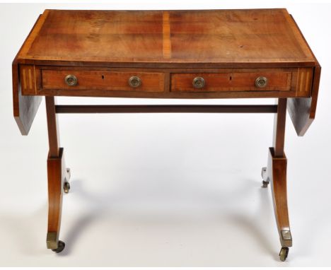 *A Regency mahogany sofa table, the panel top with satinwood crossbanding and boxwood stringing above two frieze drawers and 