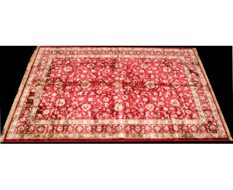 A Cashmere carpet, the red ground with scrolling foliate design, similar design to border, 119 x 77in. (303 x 195cms).