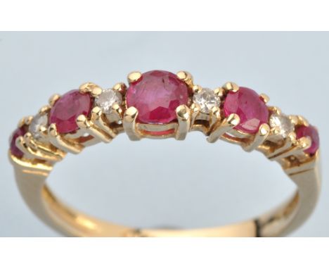 A ruby and diamond ring, the graduated circular facet cut rubies separated by brilliant cut diamonds, the shank stamped '14kt