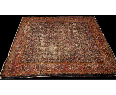 *An early 20th Century Zeigla carpet, the dark field decorated with full floral design and scrolling foliate motifs to the bo