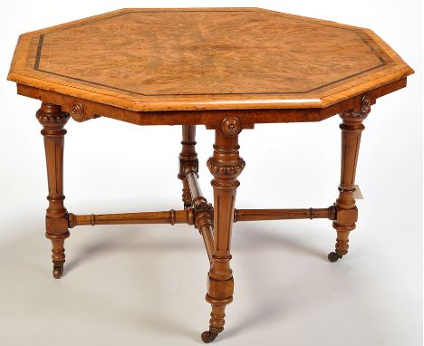 A Victorian inlaid burr walnut octagonal table, decorated with ebonised banding and boxwood stringing, the frieze with rosett