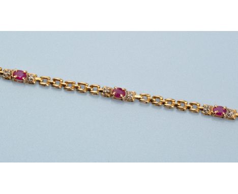 A ruby, diamond and yellow metal bracelet, set with oval facet cut rubies flanked by eight-cut diamonds and gate links, stamp