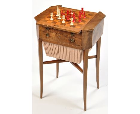 *A late Regency mahogany games/work table, the sliding panel top opening to reveal a backgammon and chess boards, bobbin draw