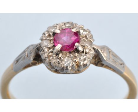 A ruby and diamond cluster ring, the circular facet cut ruby four claw set surrounded by eight eight-cut diamonds in illusion