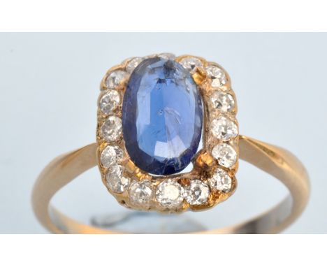 A sapphire and diamond cluster ring, the oval facet cut sapphire (loose) surrounded by old cut diamonds in openwork mount, ye