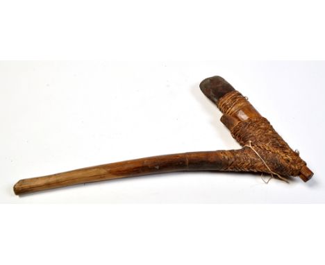 A stone bladed axe, probably of the Mangoroma Tribe, Upper Sepik River, North East Papua New Guinea, 25 1/2in. (65cms) long.