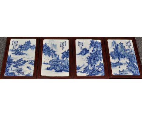 Set of four Chinese blue and white tile panels, painted with mountainous landscape detailed with figures in boats, hardwood f