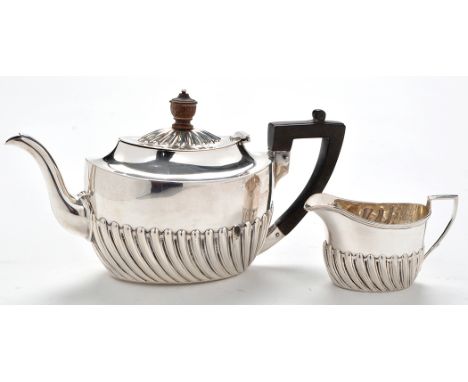 An Edwardian bachelors teapot and matching milk jug, by Harrison Bros. and Howson (George Howson), Sheffield 1903, half flute