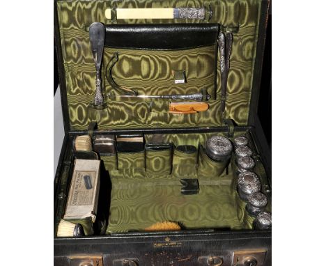 An Edwardian gentleman's leather dressing case, with fitted interior of silver mounted and other fitments, by Mappin & Webb, 