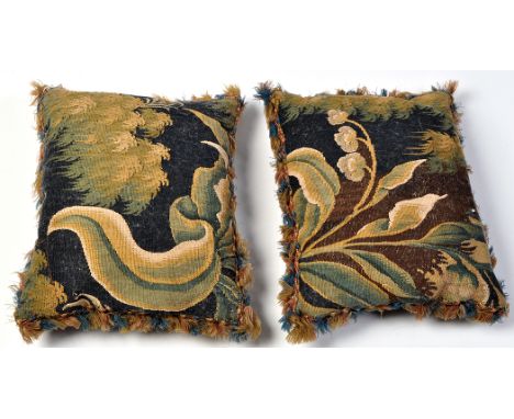 A pair of 17th/18th Century tapestry fragment cushions, of bold floral designs, with blue velvet backing and tassel edge, 17 