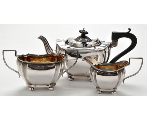 A George IV three-piece tea service, by J. Gloster Ltd, Birmingham 1915, each piece of shaped oval form, the teapot with ebon