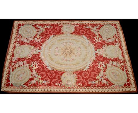 An Aubusson tapestry rug, decorated with roundels, floral swags and ribbons, 20th Century,  275 x 178cms (108 x 70in.).