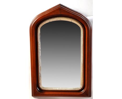 *An early 20th Century mahogany framed wall mirror, the central plate within reeded silvered surround and arched frame, 21 x 