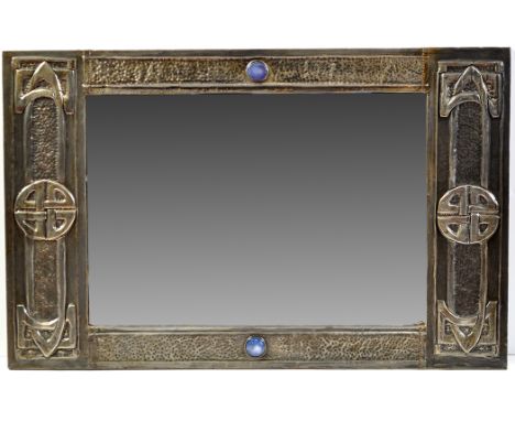An Arts & Crafts embossed pewter mounted wall mirror, the rectangular bevelled glass flanked by roundel motifs and blue ceram