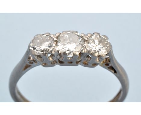 A three stone diamond ring, the graduated brilliant cut diamonds weighing a total of approximately 0.70 carats, in white meta