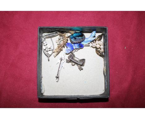 A collection of silver enamel decorated brooches and others