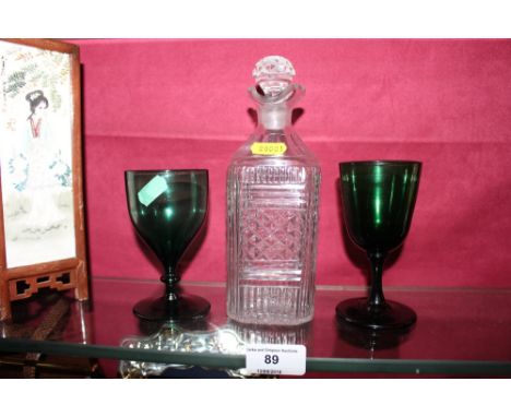 A 19th Century cut glass liqueur decanter and two 19th Century green glass wine glasses 