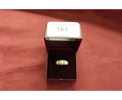 An 18ct gold pearl and diamond set ring