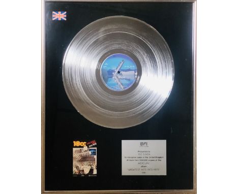 10CC GREATEST HITS BPI DISC. A mounted and framed, official BPI presentation disc with plaque to read 'Presented to Ric Dixon