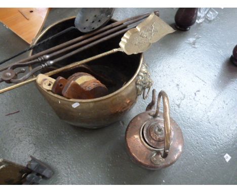 A large 19th century brass log basket, with twin lion mask ring handles, with fireside tools, three sets of small bellows (di
