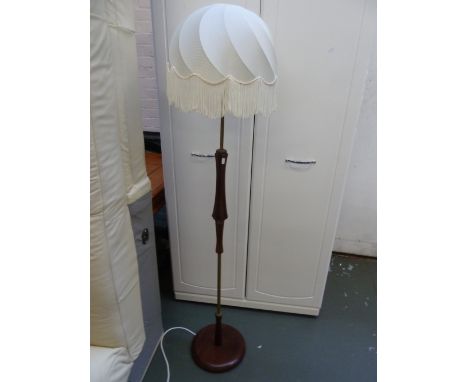 A brass and mahogany standard lamp with frilled shade