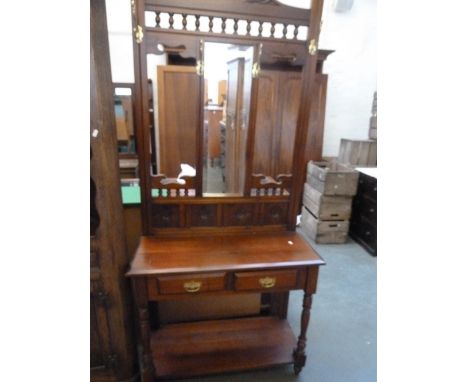 A 20th century mahogany hall stand central mirror over two short drawers, turned supports and under shelf 90cmW x 195cmH