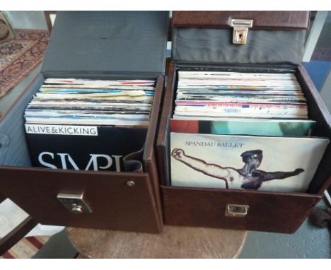 Two brown vinyl 7" record boxes containing 45 rpm 1980s pop singles such as madonna, Bronski Beat, Kool and the Gang, Scritti